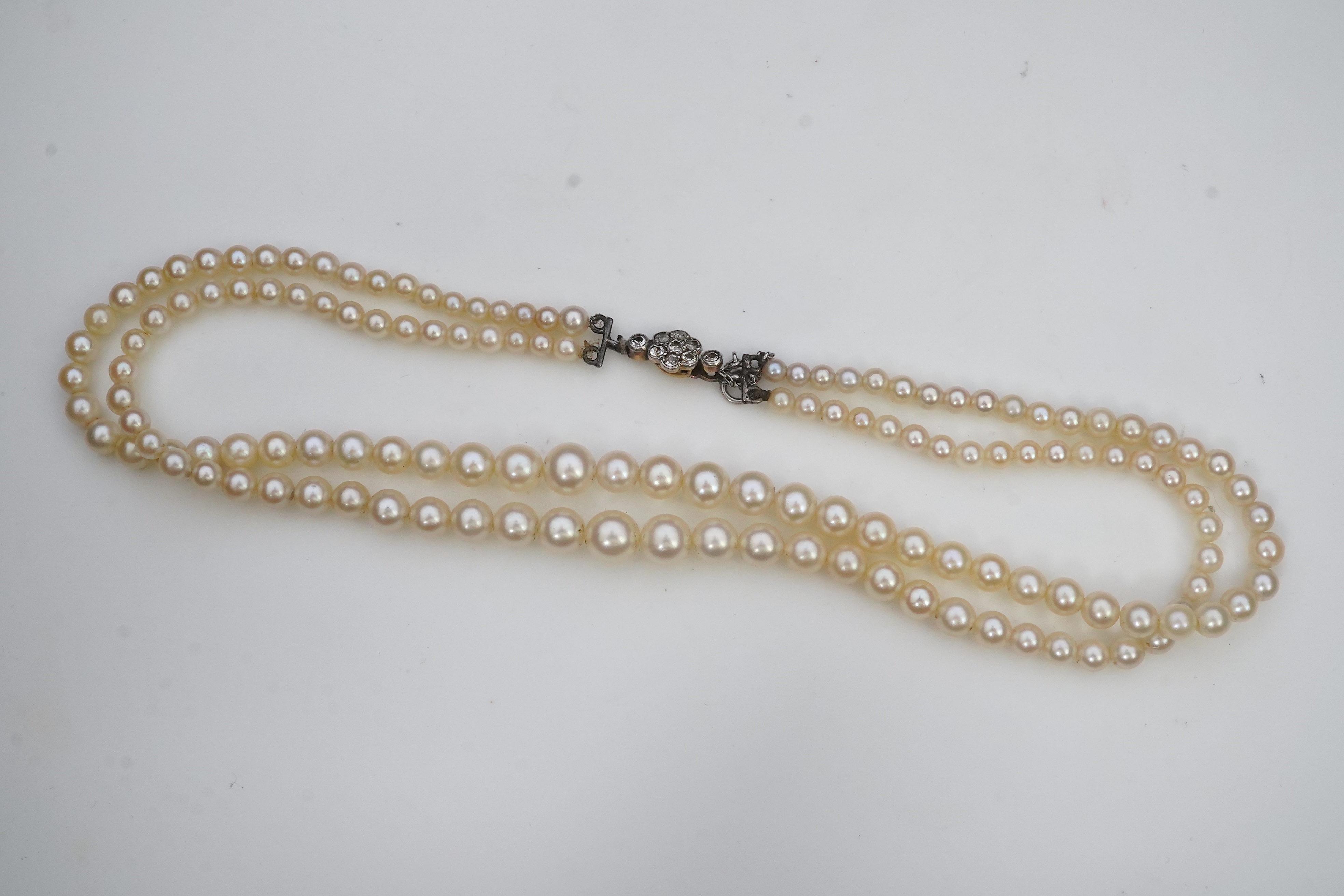 A cultured pearl and diamond necklace, early 20th century and later